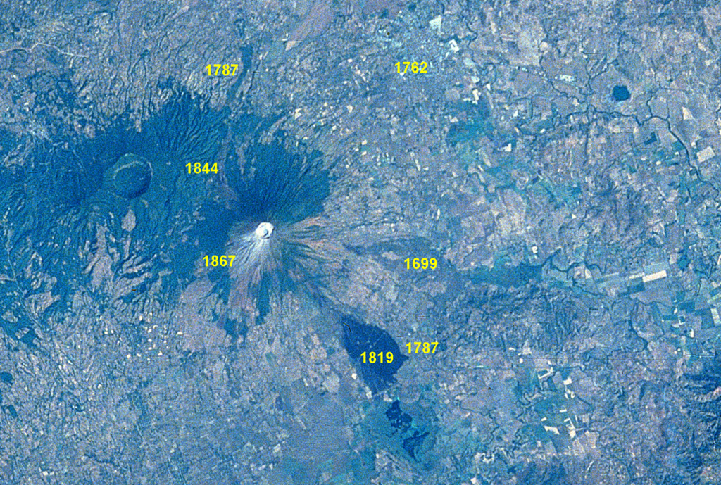 An eruption at San Miguel on September 21-23, 1787 from summit and N- and SE-flank vents produced five lava flows.  Ashfall caused extensive crop damage.  Other historical lava flows from San Miguel are labeled in this Space Shuttle image with north to the upper left.  The 1762 lava flow (faintly seen at the upper right) extended as far as the present-day city of San Miguel.  The 2.5-km-wide caldera of Chinameca volcano lies NW of San Miguel volcano, and the small dark-colored dot at the upper right is Laguna de Aramuaca maar.   NASA Space Shuttle image STS61C-31-47, 1986 (http://eol.jsc.nasa.gov/).