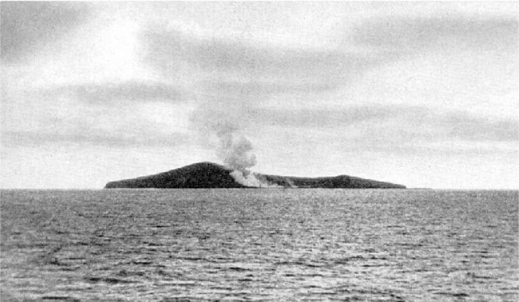 The active crater of Fonuafo'ou (formerly known as Falcon Island) through the SE breach and a plume that is dispersed to the NW by dominant SE Trade Winds. The ephemeral island in the central part of the Tonga Islands had been named after the British vessel H.M.S. Falcon, which reported the shoal in 1865. This volcano has been the site of eruptions on at least two occasions since the 19th century. By 1949 the island had eroded beneath sea level, but the summit of the volcano remains at shallow depths. Photo by A. Thompson (published in Taylor and Ewart, 1997).
