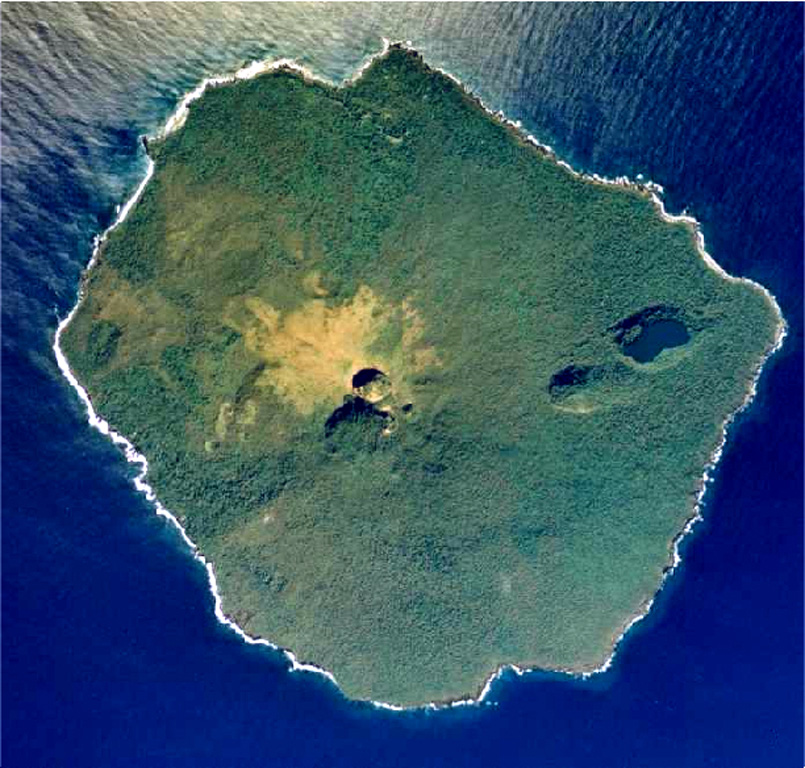 An aerial photo of Late taken in July 1990 shows the main summit crater breached to the SE and a NE graben occupied by large pit craters, the largest of which contains a saltwater lake. Except for remnants of a small lava plug in the summit crater, no fresh lava flows are present. The small, 6-km-wide island rises 1,500 m from the sea floor, with its conical summit reaching more than 500 m above sea level. Aerial photo by Tonga Ministry of Lands, Survey, and Natural Resources, 1990 (published in Taylor and Ewart, 1997).