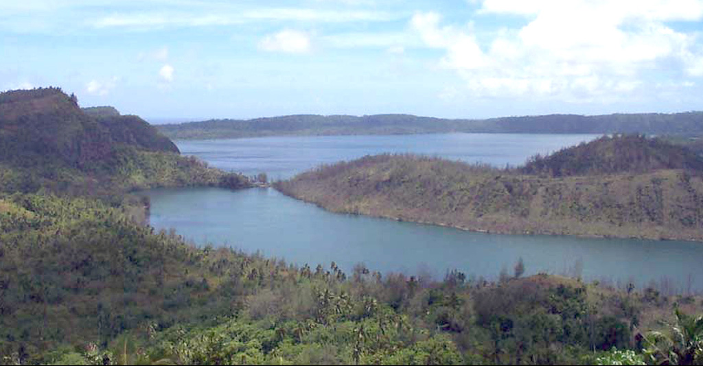 Niuafo'ou is a low, 8-km-wide ring-shaped island that forms the summit of a largely submerged shield volcano. The 5-km-wide caldera is seen here from its eastern rim, displaying caldera lakes, the large Vai Lahi (background), and the much smaller Vai Si'i (foreground). The caldera is mostly filled by Vai Lahi with a lake bottom that extends to below sea level. Historical eruptions recorded since 1814 have often damaged villages on the island. Photo by Paul Taylor (published in Taylor and Ewart, 1997).