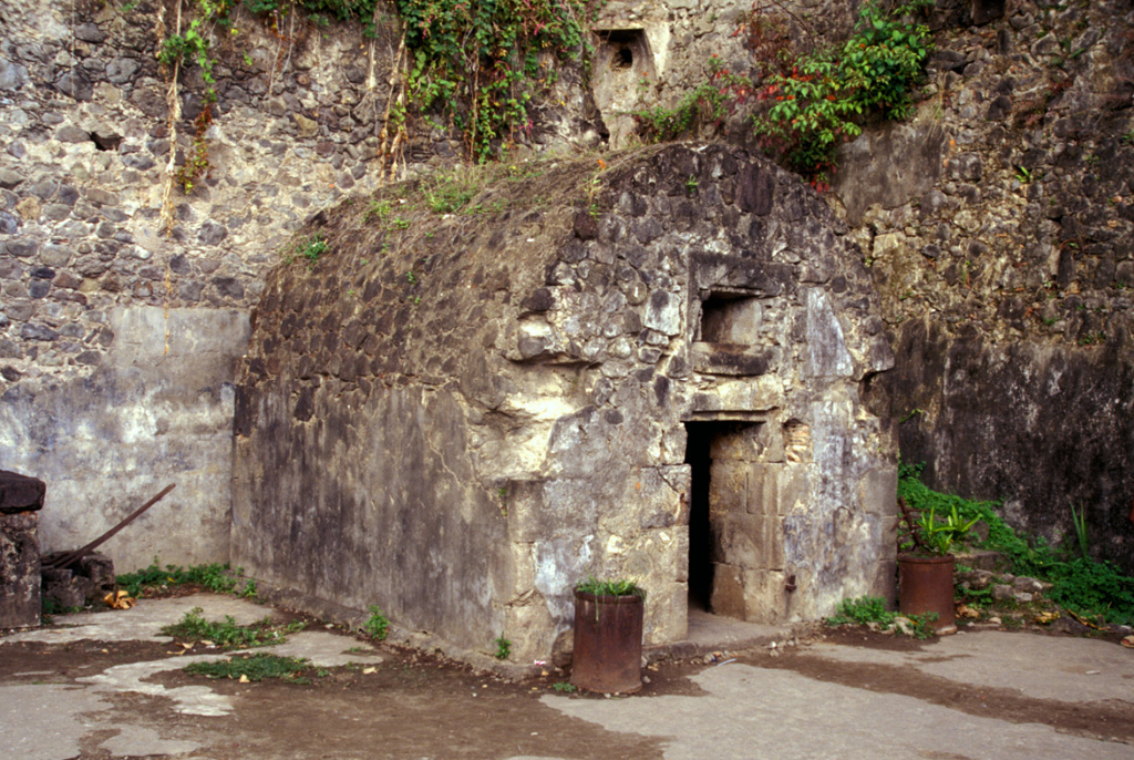 This prison cell in the city of St. Pierre housed one of the only two survivors of the 8 May 1902, eruption of Mount Pelée.  Devastating pyroclastic flows and surges swept down the SW flank of the volcano early in the morning and destroyed the city, killing 28,000 people in the world's deadliest eruption of the 20th century.    Photo by Paul Kimberly, 2002 (Smithsonian Institution).