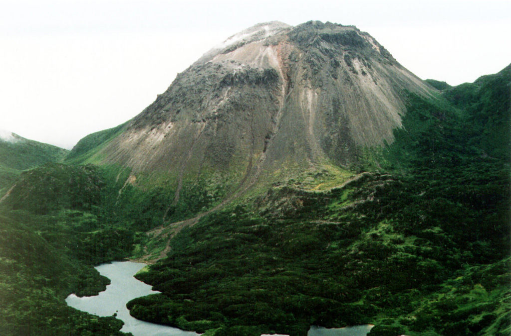 The Yakeyama (Grozny) andesitic lava dome is seen from the N with lava flows descending into Lopasnoye lake in the foreground. The Etorofu-Yakeyama (Ivan Grozny) volcano group in central Iturup Island includes multiple Holocene lava domes. Photo by A. Korablev, 1993 (Institute of Marine Geology and Geophysics, Yuzhno-Sakhalin).