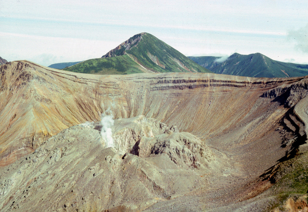 A lava dome partially fills the summit caldera of Berg, with Kolokol in the background to the S. They are part of a group of Holocene volcanoes in central Urup Island that is named after the most prominent cone.  Photo courtesy of Alexandr Rybin (Institute of Marine Geology and Geophysics, Yuzhno-Sakhalin).