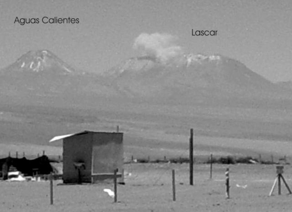 An ash plume rises above Láscar volcano on October 27, 2002, as seen from Pozo Tres, 60 km to the NW.  Minor ash eruptions had been observed on 3 occasions at five-minute intervals on October 26, producing plumes that rose about 300 m above the summit crater.  On the 27th two explosions were observed; the plume from the 2nd explosion reached at least 1.5 km above the crater.   Photo by Jose Viramonte (Universidad Nacional de Salta, published in Bulletin of the Global Volcanism Network), 2002.