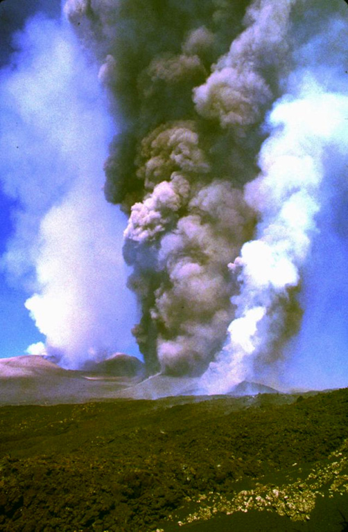 Two days after the onset of the eruption on the morning of 28 October 2002, the southern vents of Etna produce ash and gas plumes. The white plume on the right comes from the lava vent, and the plume in the left background is from the summit craters. Photo by Jean-Claude Tanguy, 2002 (University of Paris).