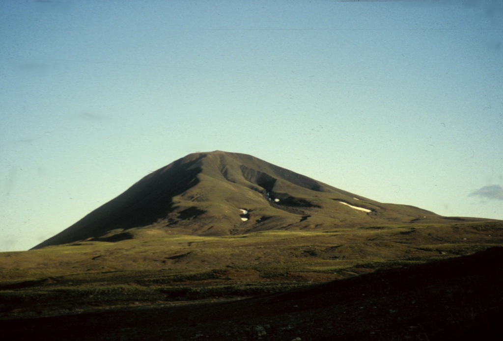 South Tuya, seen here from the north, is one of six subglacial volcanoes close to Tuya Lake, in north-central British Columbia. The cone seen above comprises loose volcanic debris as well as dikes of basaltic rock intruded into the volcanic pile. The base of the volcano comprises pillow lavas and hyaloclastite, indicating that the volcano formed either beneath ice or within a large lake. Several small postglacial cones and lava flows have been reported in this area. Photo by Ben Edwards, 2003 (Dickinson College, Pennsylvania).