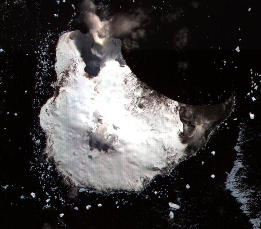 Glacier-covered Mount Michael stratovolcano dominates Saunders Island.  Cordelia Bay lies between the Blackstone Plain (top) and the snow-free Ashen Hills (right), a cluster of parasitic cones on the SE flank.  Ash clouds were reported from the summit crater in 1819, and an effusive eruption was inferred to have occurred from a north-flank fissure around the turn of the 19th century.  Recent AVHRR and MODIS satellite imagery has revealed evidence for lava lake activity in the summit crater of Mount Michael. ASTER satellite image, 2002 (National Aeronautical and Space Administration, courtesy of ASTER science team).