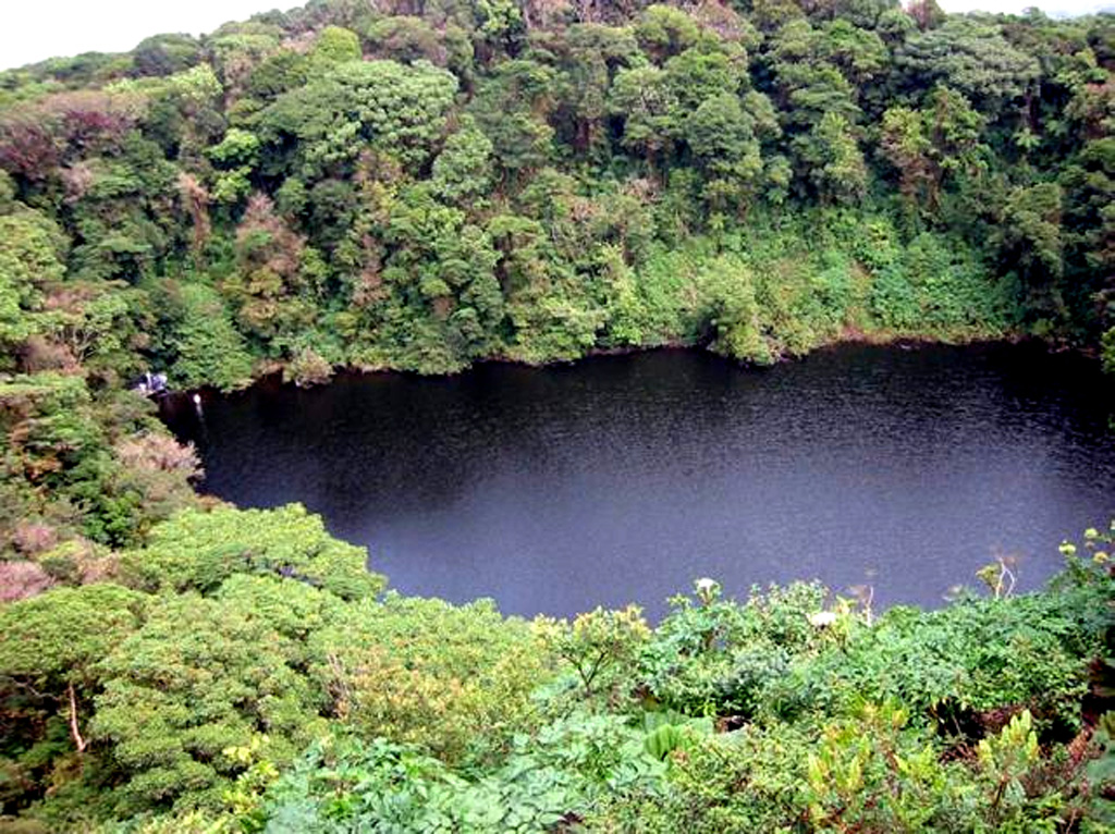 The roughly 300-m-wide Barva crater lake is surrounded by dense forest. The clear waters of the shallow lake are about 8 m deep, and a pH of 4-5 was measured in December 2002.  Photo by Raul Mora, 2002 (University of Costa Rica).