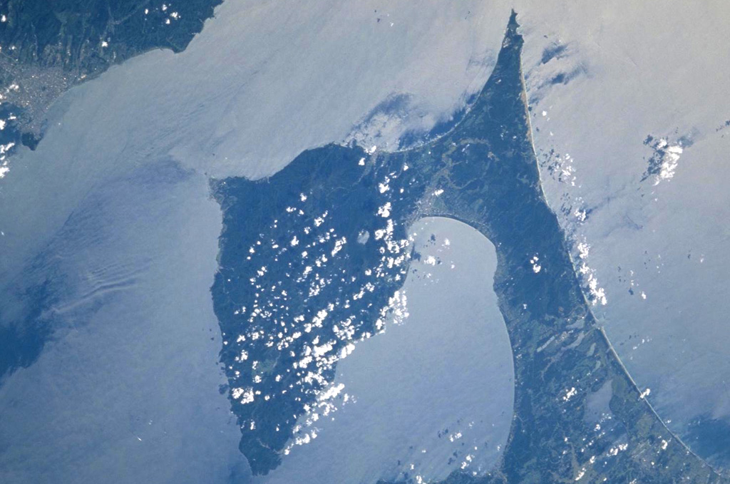 The prominent Shimokita Peninsula is located at the NE tip of Honshu just above and to the left of the center of this NASA Space Shuttle image, with N (and part of the island of Hokkaido) to the upper left. The volcano is Pleistocene in age, although fumarolic activity continues. Osoreyama volcano lies below Mutsu-Hiuchidake near the southern coast of the peninsula, north of Mutsu Bay. NASA Space Shuttle image STS106-720-2, 2000 (http://eol.jsc.nasa.gov/).