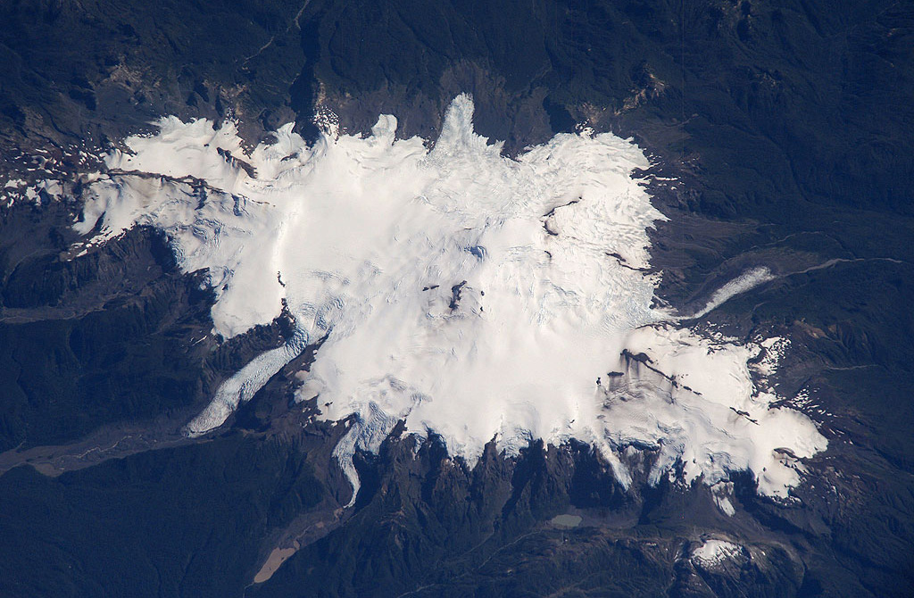 Glacier-covered Volcán Minchinmávida is elongated along a NE-SW direction.  The volcano has a mostly obscured 3-km-wide caldera, and a youthful eruptive center is located on the ENE side of the complex.  An eruption from Minchinmávida was reported in 1742.  Darwin observed the volcano in activity in 1834 on his renowned voyage that took him to the Galápagos Islands.   NASA International Space Station image ISS006-E-42260, 2003 (http://eol.jsc.nasa.gov/).
