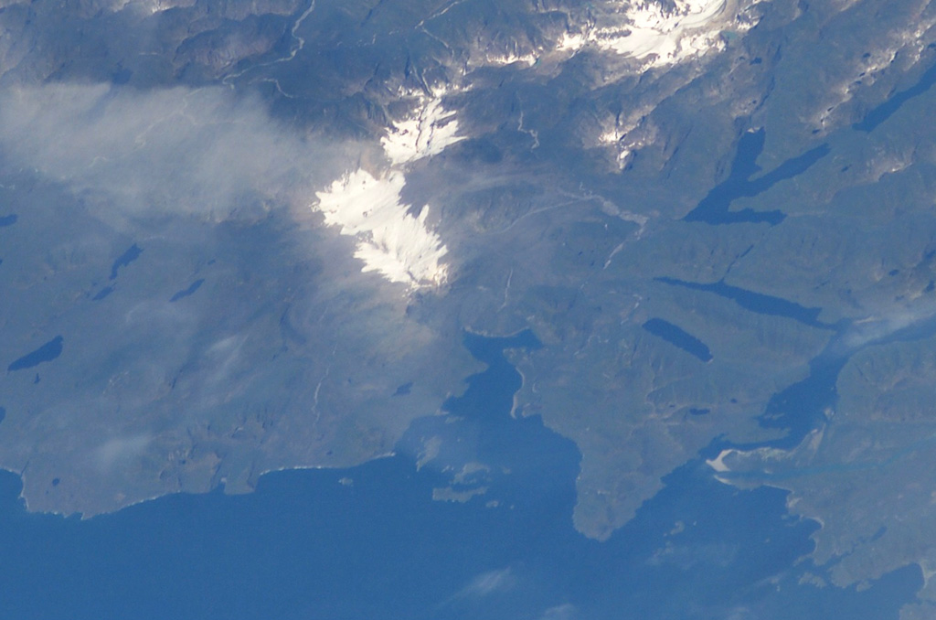 The elongated, glacier-covered massif near the center of this NASA International Space Station image (with north to the left) is Yanteles volcano in southern Chile.  The volcano is composed of five glacier-capped peaks along an 8-km-long NE-trending ridge.  Historical eruptions from this 2042-m-high, andesitic volcanic complex are uncertain.   NASA International Space Station image ISS006-E-42998, 2003 (http://eol.jsc.nasa.gov/).