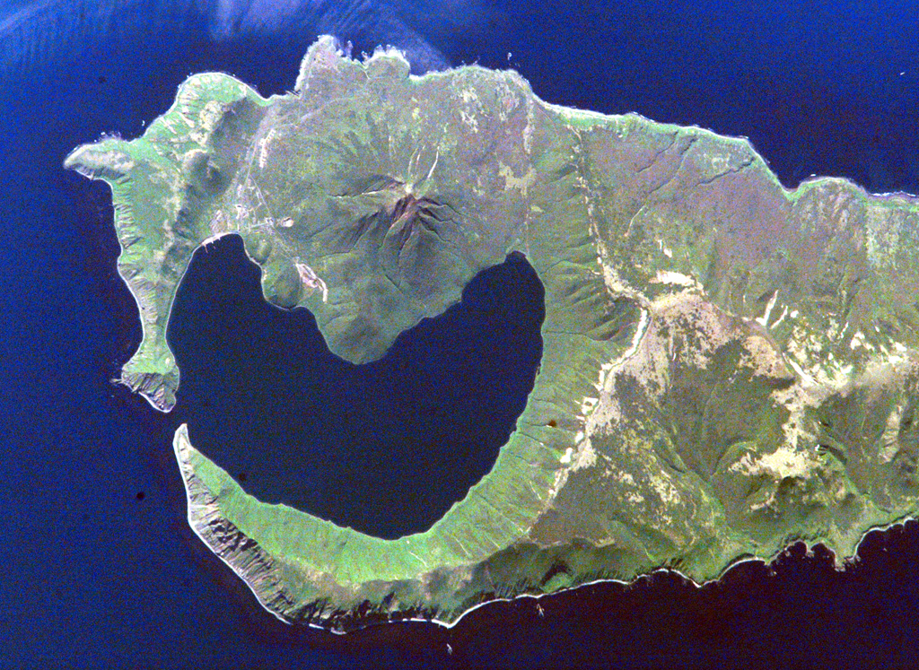 A narrow gap in the NNE rim of 7.5-km-wide Pleistocene Brouton caldera on Uratman volcano in the Kuril Islands has led to the formation of the bay. The caldera floor lies 250 m beneath the ocean surface, and the rim rises 450 m above that. The central Uratman cone grew to a height of about 680 m during the Holocene. NASA International Space Station image ISS005-E-6514, 2002 (http://eol.jsc.nasa.gov/).