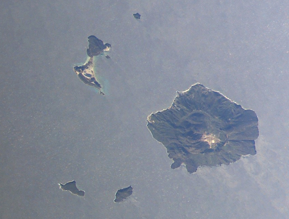 The island of Yali (upper left) and the island of Nisyros Island (lower right) are shown this NASA International Space Station image (with N to the upper left). Yali contains two distinct segments connected by a narrow isthmus formed of modern reef sediments and consists of rhyolitic obsidian domes at the NE end and pumice-fall deposits at the SW end. A caldera 3-4 km wide, much of the W side of which is filled by post-collapse lava domes, is visible on Nisyros Island. NASA International Space Station image ISS006-E-30975, 2003 (http://eol.jsc.nasa.gov/).