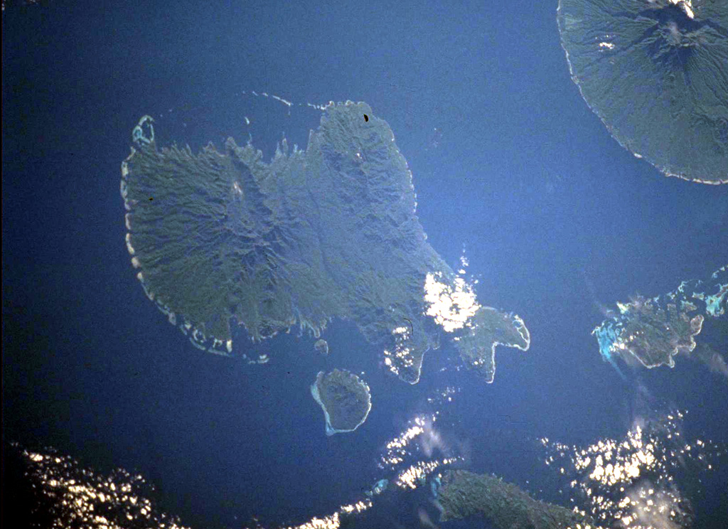 Vella Lavella Island (left center) lies in the New Georgia Islands in the Solomon Islands chain. North is to the upper left in this NASA International Space Station image. Nonda volcano, the youngest volcanic feature of Vella Lavella Island, is a lava dome located within a crater to the N. The Paraso thermal area is the (light-colored area at center) contains solfataras, hot springs, and boiling mud pots. Kolombangara Island is at the upper right. NASA International Space Station image ISS002-727A-2, 2001 (http://eol.jsc.nasa.gov/).