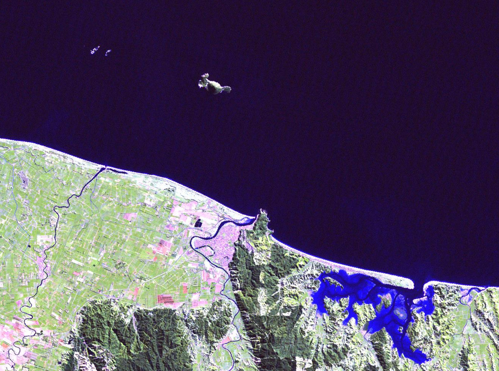 Moutohora (Whale) Island is the elongated island 11 km offshore from the city of Whakatane in the center of this Landsat image. The central dome complex on the 15 x 5 km wide island is about 350 m high and flanked by two lava domes, Pa Hill Dome (also known as West Dome) at the NW tip of the island and East Dome at the opposite end. Eruptive activity ceased during the Pleistocene but thermal activity continues. Rurima Rocks and Moutoko Island lie WNW, and the large bay at the lower right is Ohiwa Harbour. NASA Landsat image, 2000 (courtesy of Hawaii Synergy Project, Univ. of Hawaii Institute of Geophysics & Planetology).