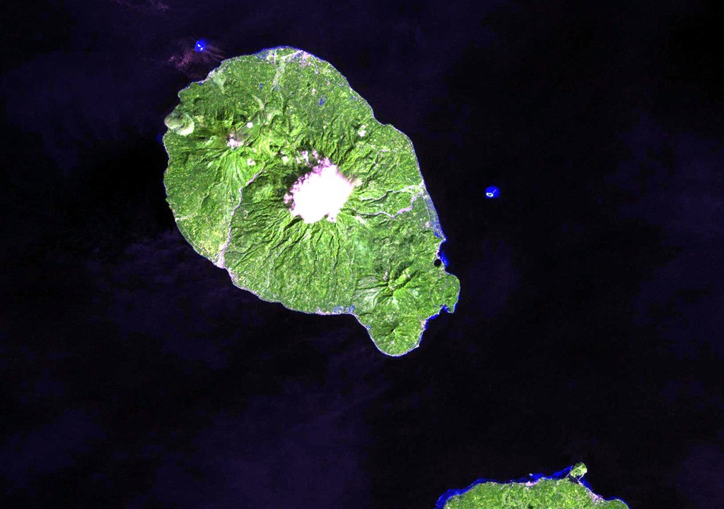 Camiguin Island, just off the coast of north-central Mindanao Island (lower right), consists of four overlapping cones. Cloud-covered Mt. Mambajao forms the high point of the island. The youngest volcano, Hibok-Hibok (also known as Catarman) at the NW end of the island, has been historically active. Major eruptions during 1871-75 and 1948-53 formed flank lava domes at Hibok-Hibok and produced pyroclastic flows that devastated coastal villages. NASA Landsat image, 2002 (courtesy of Hawaii Synergy Project, Univ. of Hawaii Institute of Geophysics & Planetology).