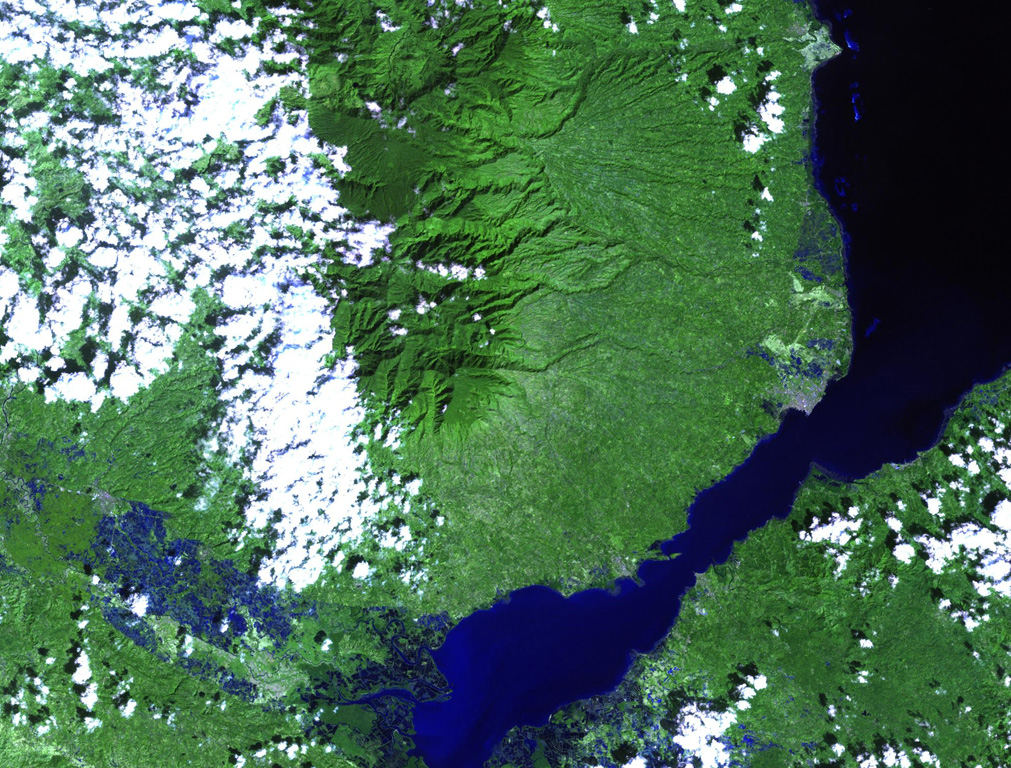 The forested Malindang stratovolcano (center) is located on the western margin of Iligan Bay in north-central Mindanao. The volcano contains a small summit caldera and legends discuss a large eruption. Reports of increased activity in 1991 at the time of tectonic earthquakes prompted widespread evacuations, but an eruption did not occur. NASA Landsat image, 2002 (courtesy of Hawaii Synergy Project, Univ. of Hawaii Institute of Geophysics & Planetology).