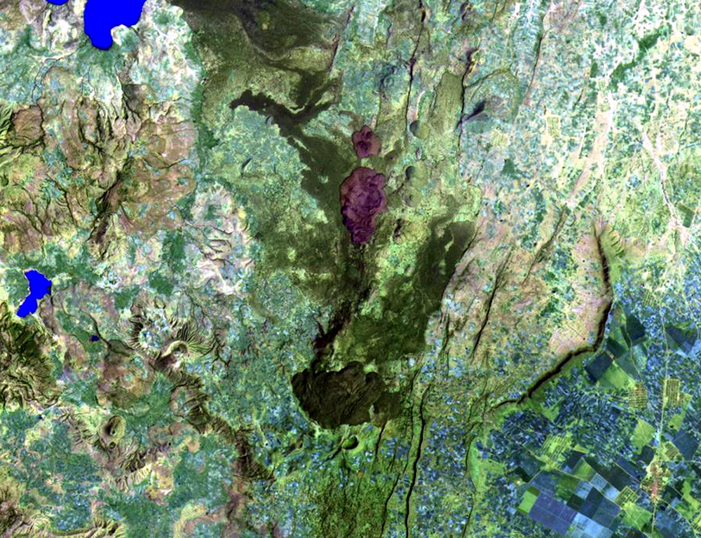 The small crater at the bottom-center of this Landsat image is Tullu Moje, a trachytic-to-rhyolitic pumice cone with a 700-m-wide summit crater. The northern base of the cone is covered by an obsidian lava flow. Two other obsidian flows are prominent 5 km to the north. The most recent of these silicic lava flows were erupted as recently as about 1900 CE. The same fissure system has also erupted prehistoric basaltic lava flows. The SE tip of Lake Koka lies at the upper left. The Bora-Bericcio complex is also to the upper left. NASA Landsat image, 1999 (courtesy of Hawaii Synergy Project, Univ. of Hawaii Institute of Geophysics & Planetology).