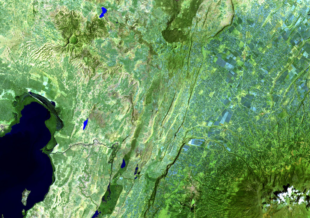 A large unnamed area of young basaltic lava flows and a possible small cinder cone is located on the floor of the Ethiopian Rift Valley SW of Tullu Moje volcano, which produced the dark-colored obsidian lava flow at the top-center of this Landsat image. The basaltic flows occupy a NE-SW-trending zone near the active eastern margin of the rift valley, NE of Lake Zwai (lower left) and NW of the 4,000-m-high Pleistocene Ch'llalo (Cilallo) volcano (lower right). NASA Landsat image, 1999 (courtesy of Hawaii Synergy Project, Univ. of Hawaii Institute of Geophysics & Planetology).