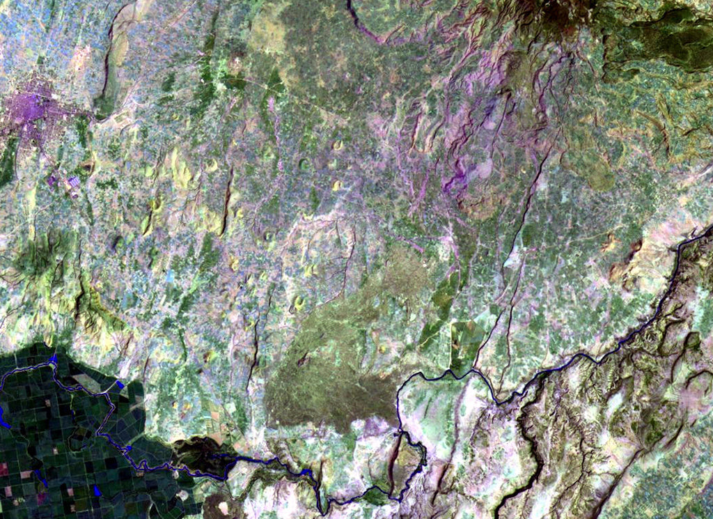 The Sodore volcanic field is an extensive 15 x 25 km wide group of Pleistocene and Holocene pyroclastic cones and lava flows that occupies the floor of the Ethiopian Rift Valley. The basaltic flows in this Landsat image are located NE of the Wonji Sugar Estate Farm (the fields at the lower left) and SW of the Boset-Bericha volcanic complex, which produced the lava flows seen at the upper right. The flows also cover an area west of the Boset-Bericha complex. NASA Landsat image, 1999 (courtesy of Hawaii Synergy Project, Univ. of Hawaii Institute of Geophysics & Planetology).