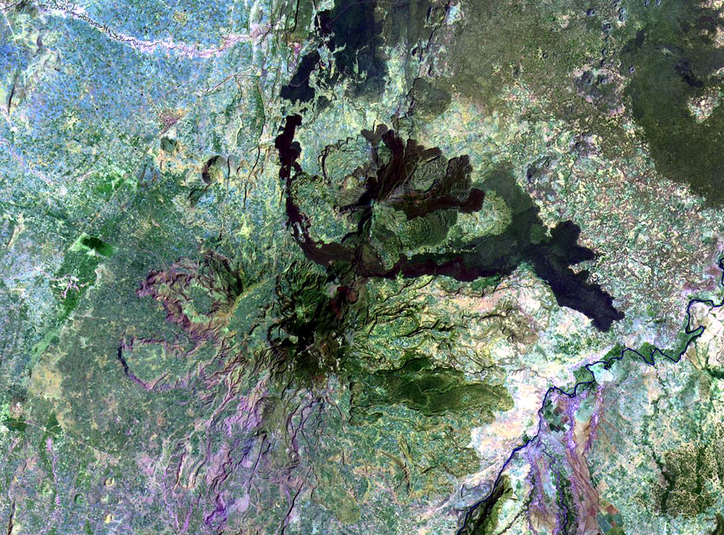 These two closely-spaced volcanic centers, Boset (Boseti-Gudda) and Bericha (Boseti-Bericcia) are located in the Ethiopian Rift valley. Boset, the SSW center (also known as Gudda), is below and to the left of the center of this Landsat image, while the NNE center, Bericha, lies just above the center of the image. Fissures connecting the two have erupted basaltic lava flows. NASA Landsat image, 1999 (courtesy of Hawaii Synergy Project, Univ. of Hawaii Institute of Geophysics & Planetology).