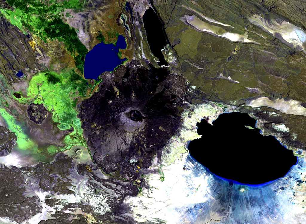 Dama Ali is a broad shield volcano that rises above the NW shore of Lake Abhe (right) at the S end of the Kalo Plain and was the most likely source of an eruption reported to have occurred in 1631. Nested circular craters are located at the summit and an arcuate chain of rhyolitic lava domes can be seen on the N, W, and S flanks. Major fumarolic activity occurs in the summit crater and abundant hot springs occur on the volcano. NASA Landsat image, 1999 (courtesy of Hawaii Synergy Project, Univ. of Hawaii Institute of Geophysics & Planetology).