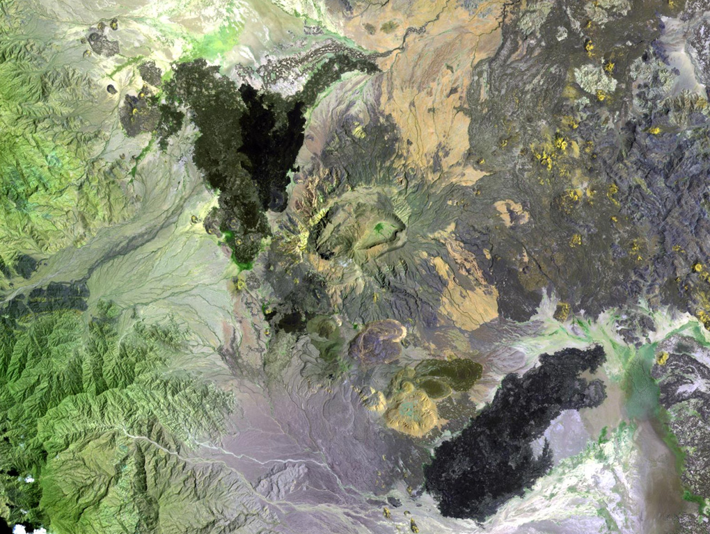 The Ma Alalta stratovolcano (center), also known as Pierre Pruvost, is located W of the Danakil depression. There are two elongate, nested summit calderas, 6 km and 4 km wide in the long direction. Young basaltic lava flows were erupted on the NW, SE, and E flanks of the volcano, and young pantellerite obsidian domes and lava flows were erupted on the S flank. NASA Landsat image, 1999 (courtesy of Hawaii Synergy Project, Univ. of Hawaii Institute of Geophysics & Planetology).
