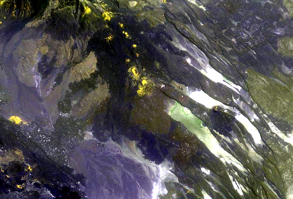 The chain of pyroclastic cones and lava flows extending diagonally down from the upper-left portion of this Landsat image is the southern portion of the Mousa Alli volcanic complex. The flanks of its neighbor to the SW, Manda Inakir, are visible at the extreme lower left. Prominent faults at the right cut lava flows of the Pliocene-Pleistocene stratoid series of the Afar region. NASA Landsat image, 1999 (courtesy of Hawaii Synergy Project, Univ. of Hawaii Institute of Geophysics & Planetology).