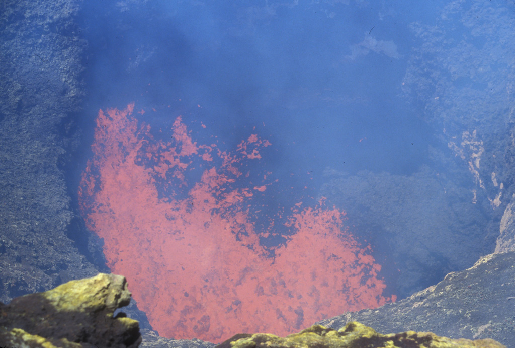 Incandescent spatter and bombs ejected from a lava lake at the bottom of a steep-sided, ~40-m-wide inner crater are seen from the SW rim of Villarrica's outer crater on November 19, 2004.  Incandescence was seen above the summit crater the nights of August 5-6 and October 27-28, 2004 and frequently during November and December.  Strombolian explosions ejected material to 100 m the night of December 12-13.  Ground observations of summit lava lake activity and minor strombolian explosions were continued into 2006. Photo by Lee Siebert, 2004 (Smithsonian Institution).