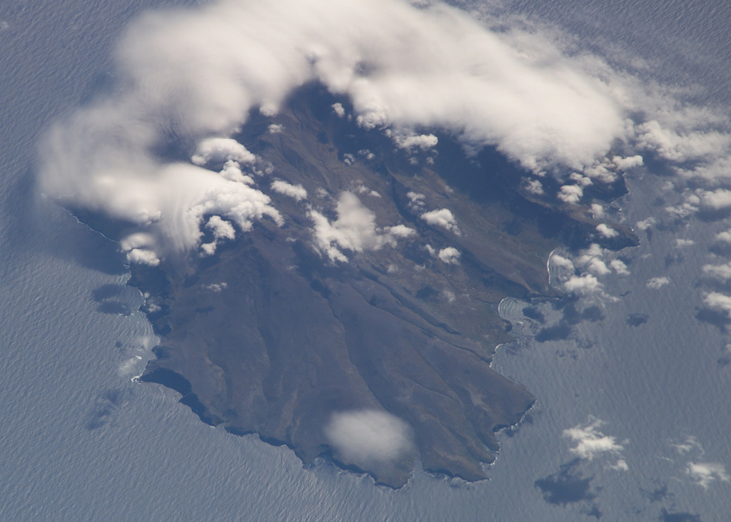 Ile de la Possession, located immediately west of Ile de l'Est in the Crozet archipelago, is seen in this NASA International Space Station image (N at the top). The 14 x 19 km island is structurally complex and has an irregular shoreline. It consists of a stratovolcano intruded by ring and cone dikes and modified by block faulting, marine erosion, and uplift. Young scoria cones of probable Holocene age are distributed over much of the island. NASA International Space Station image ISS006-E-37990, 2003 (http://eol.jsc.nasa.gov/).