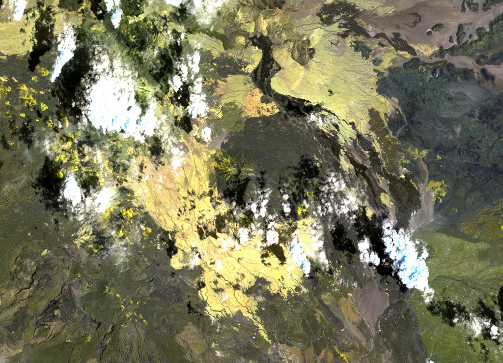 The roughly 1-km-wide caldera is located at the western side of the dark-colored lava field, at the summit of Sork Ale volcano (at the center of this NASA Landsat image, N is at the top). This stratovolcano, also known as Asdaga, is located perpendicular to the orientation of three larger stratovolcanoes trending NE-SW at the southern end of the Danakil Alps. The ages of recent eruptions are not certain. NASA Landsat image, 1999 (courtesy of Hawaii Synergy Project, Univ. of Hawaii Institute of Geophysics & Planetology).
