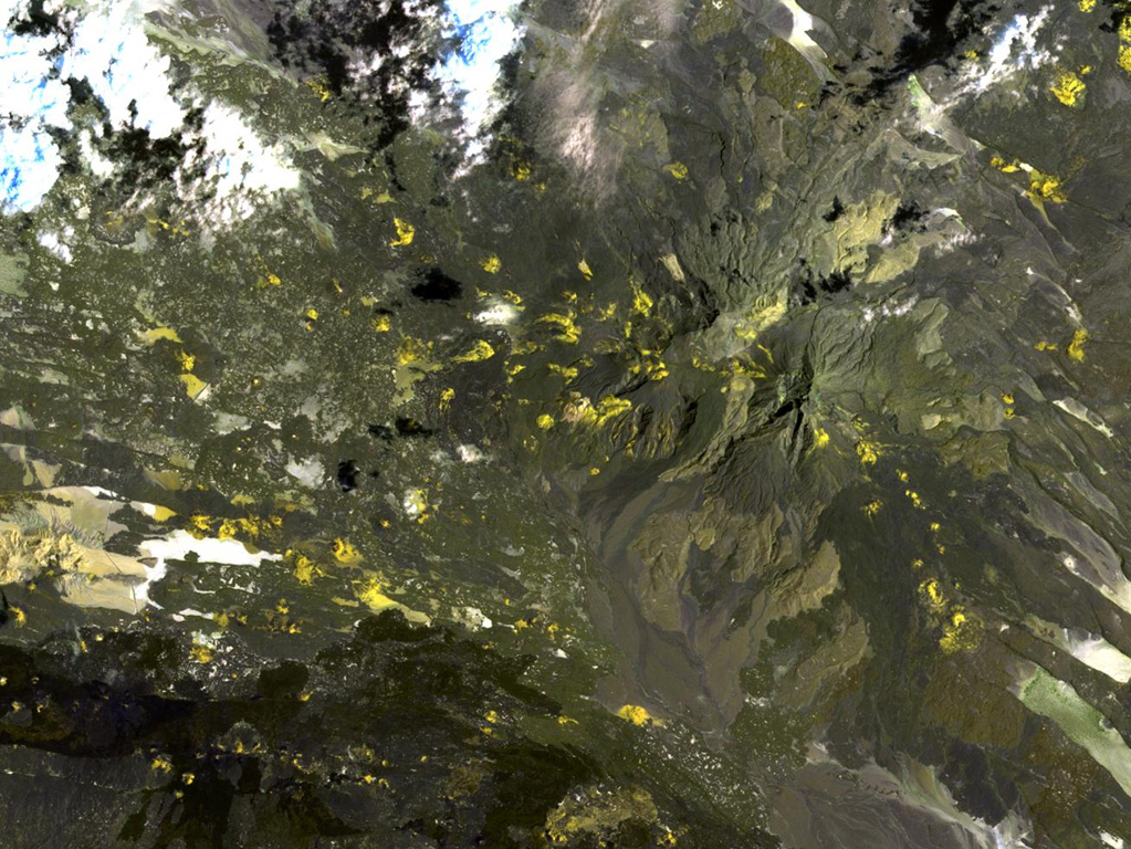 Mousa Alli volcano dominates the right-hand side of this NASA Landsat image and is located on the border between Ethiopia, Eritrea, and Djibouti. This volcano is the most prominent topographic feature in this area and towers above its neighbor to the SW, Manda Inakir, visible at the lower left. Yellow-colored basaltic pyroclastic cones and associated lava flows occupy the SE and NW flanks. NASA Landsat image, 1999 (courtesy of Hawaii Synergy Project, Univ. of Hawaii Institute of Geophysics & Planetology).