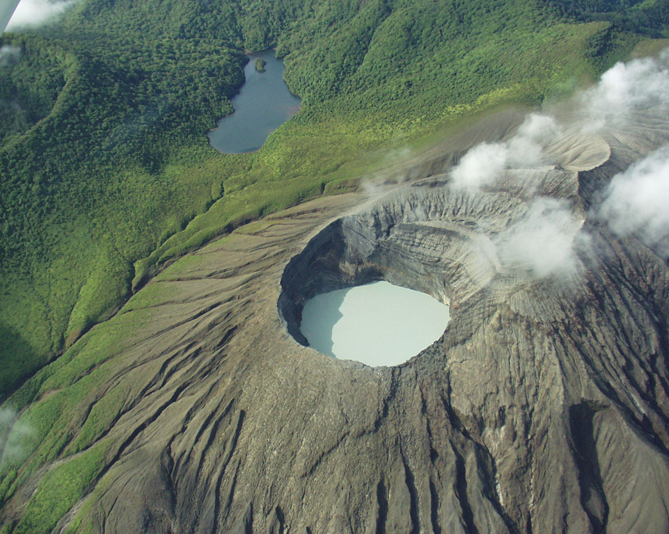 This view from the N looks into the acidic Cráter Activo lake with layered pyroclastic deposits exposed in the SW crater wall. The crater rim of the forested Rincón de la Vieja cone is to the upper left, with the non-volcanic Jilgueros lake at the top.  Photo by Eliecer Duarte (OVSICORI-UNA).