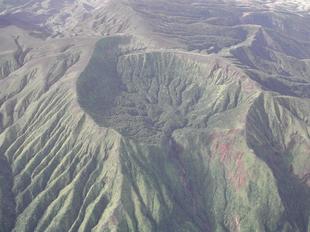 This eroded crater lies near the western margin of Rincón de la Vieja, seen here from the SE. This roughly 1-km-wide crater is about 2 km W of Cráter Activo. On the lower left flank, steep erosional gullies have formed through erosion.  Photo by Eliecer Duarte (OVSICORI-UNA).