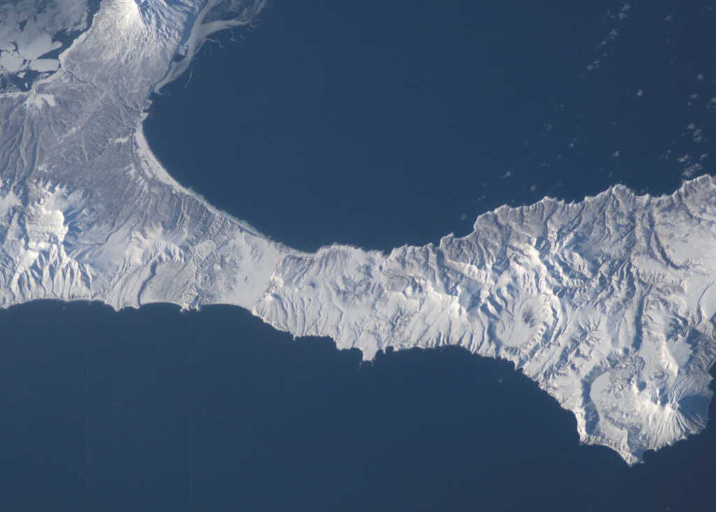 The small late Pleistocene or early Holocene cones of Golets and Tornyi are located just to the east (right) of the low-lying floor of the Vetrovoi Isthmus Caldera in northern Iturup Island. At the lower right in this NASA International Space Station image (N is to the top-right) right is Moyorodake volcano, and the Pleistocene Tsirk caldera is to the left of that. NASA International Space Station image ISS010-E-13393, 2005 (http://eol.jsc.nasa.gov/).