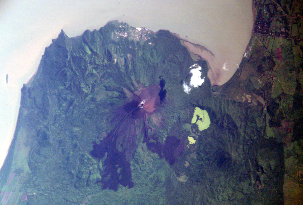 Fresh-looking, dark-colored lava flows from the 1905 eruption of Momotombo volcano are prominent in this NASA International Space Station image with north to the top.  The NW-most flow cascaded into Monte Galán caldera, with the greenish Laguna Monte Galán near its southern rim.  Laguna Las Piedras lies near the center of the caldera, near the toe of the NW lava flow.  The light-colored developed area south of the summit along the shore of Lake Managua is the Momotombo geothermal field. NASA International Space Station image ISS005-E-16247, 2002 (http://eol.jsc.nasa.gov/).