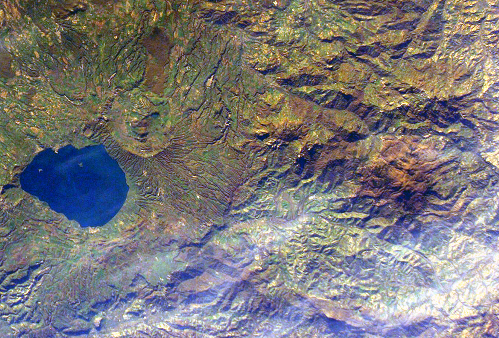 The small Amiata lava dome complex (just right of the center of this image), is located about 20 km NW of Lake Bolsena (left-center) in the southern Tuscany region of Italy. The largest of the domes is Monte Amiata (La Vetta). No eruptive activity has occurred during the Holocene, but thermal activity continues at a producing geothermal field. NASA International Space Station image ISS008-E-7007, 2003 (http://eol.jsc.nasa.gov/).