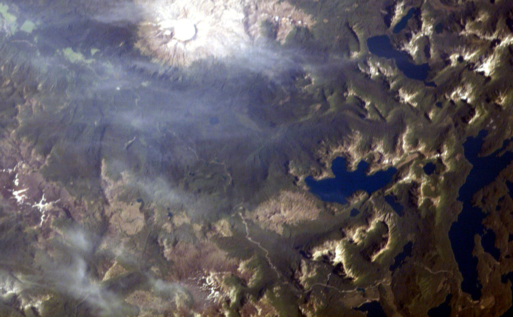 The small volcanic center with the crater outlined by snow just to the left of the bottom center of this NASA International Space Station image (with north to the upper right) is Cerro Pantoja.  This eroded basaltic-andesite volcano of Pleistocene age along the Chile-Argentina border has a Holocene cinder cone on the Argentinian side.  The deep blue lake at right-center is Lago Constancia, and the large stratovolcano with a snow-filled summit crater at the top of the image is Puyehue.      NASA International Space Station image ISS006-E-40413, 2003 (http://eol.jsc.nasa.gov/).