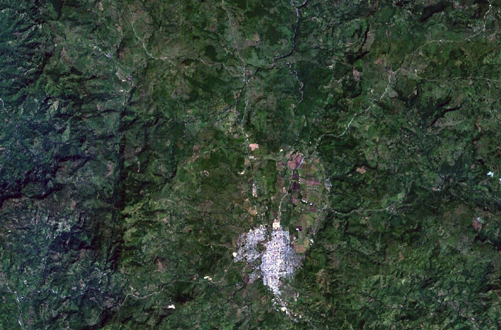 The area NW of the town of Estelí (bottom-center) and east of the prominent fault-bound valley at the left contains sparsely vegetated lava flows of the Estelí volcanic field.  The flows were mostly erupted from fissure vents located in valleys in the northern interior highlands of Nicaragua between the town of Estelí and the border with Honduras.   NASA Landsat 7 image (worldwind.arc.nasa.gov)