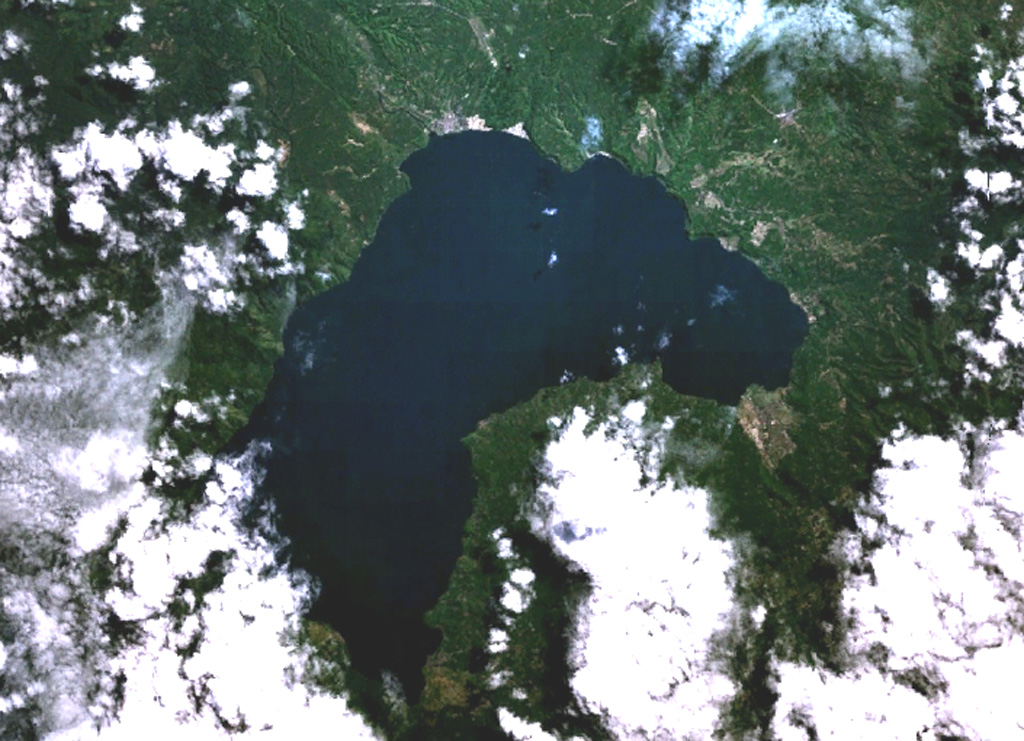 Lake Ranau partially fills the 8 x 13 km Ranau caldera. A morphologically young post-caldera stratovolcano, Gunung Semuning, its summit obscured by clouds below the bottom center lake shore in this NASA Landsat image (N is to the top), was constructed within the SE side of the caldera to a height of more than 1,600 m above the caldera lake surface. The age of the most recent eruptions at Ranau are not known, but fish kills and the smell of sulfur in the late 19th and early 20th centuries may have been related to eruptions within the lake. NASA Landsat 7 image (worldwind.arc.nasa.gov)