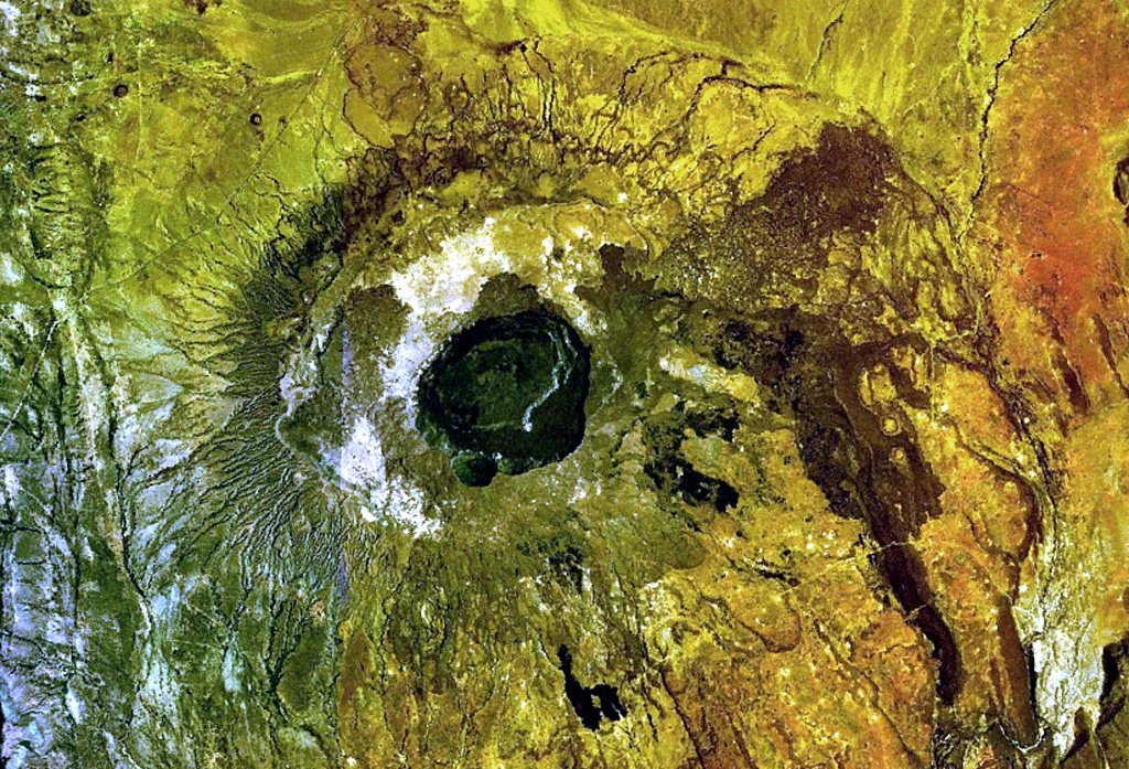The central caldera of Suswa, the southernmost caldera of the Kenya rift, contains a 5-km-wide caldera. Construction of an early shield volcano was followed by eruption of voluminous pyroclastic flows and lava flows that accompanied formation of the caldera. The latest eruptions have originated from vents that have issued still-unvegetated lava flows that may be only a century or so old. N is to the top in this NASA Landsat image. NASA Landsat 7 image (worldwind.arc.nasa.gov)