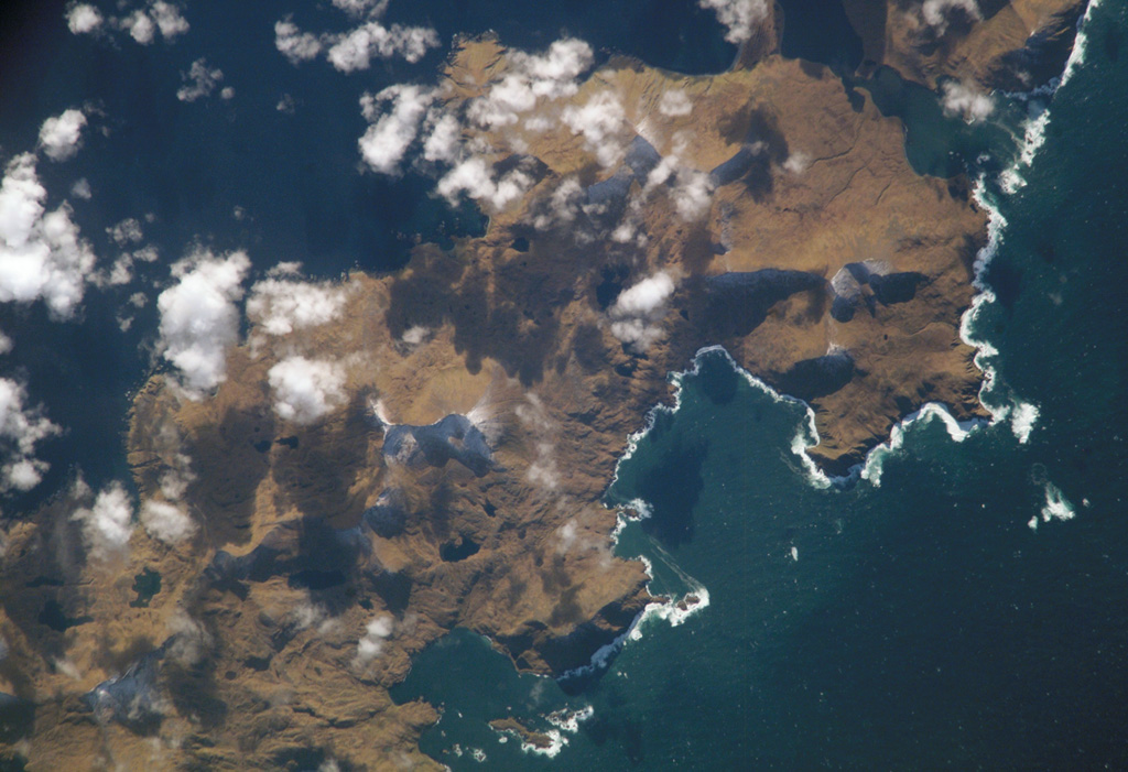 Sergief volcano on SW Atka Island lies below and to the left of the center of this NASA International Space Station image (with north to the lower right).  The SW part of the Atka Island is older and less topographically rugged than the NE part of the island, and the age of this small stratovolcano is not precisely known.  The large embayment at the right-center is Podsopochni Bay.  Portage Lagoon and Sergief Bay at the upper right almost bisect the island. NASA International Space Station image ISS005-E-18300, 2002 (http://eol.jsc.nasa.gov/).