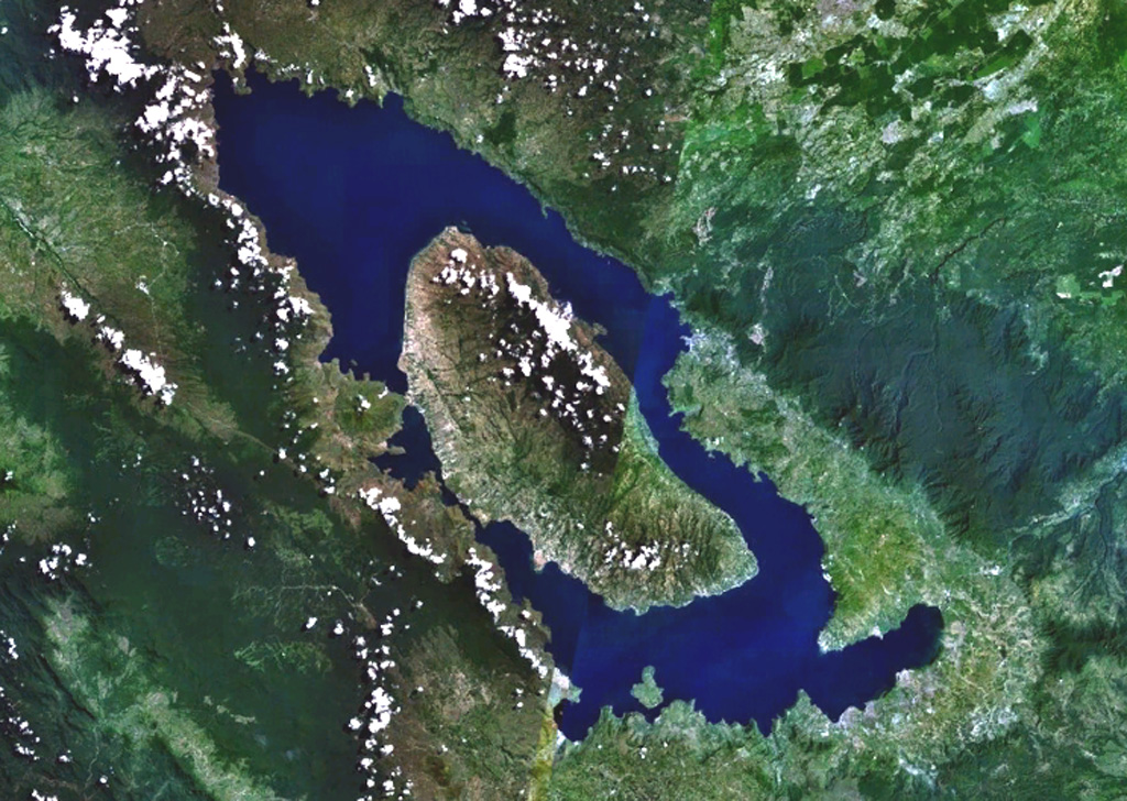 Toba is Earth's largest Quaternary caldera and is partially filled by Lake Toba, seen here in a NASA Landsat satellite image (N is to the top). The 35 x 100 km caldera formed during four major ignimbrite-forming eruptions in the Pleistocene, the latest of which occurred about 74,000 years ago. The large island of Samosir is an uplifted resurgent dome.  NASA Landsat 7 image (worldwind.arc.nasa.gov)