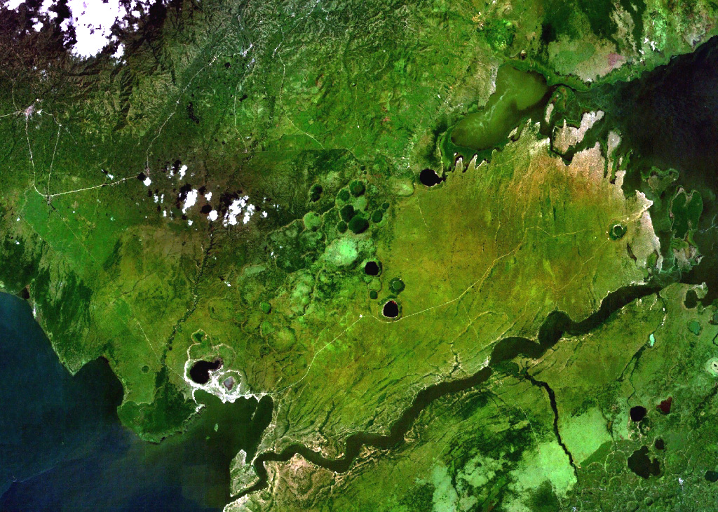 Lake-filled and dry maars of the Katwe-Kikorongo volcanic field are shown in the center of this NASA Landsat image (with N to the top). The volcanic field lies above the river channel connecting Lake Edward (lower left) with Lake George (upper right) in the Western Rift Valley of Uganda. Dark-colored Lake Katwe (lower left) is a shallow 3-km-long body of water that occupies two of three intersecting craters immediately NE of Lake Edward. Local folk tales suggest that volcanism in the Katwe-Kikorongo area has continued into historical times. NASA Landsat 7 image (worldwind.arc.nasa.gov)