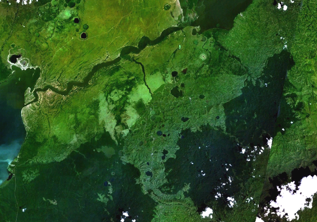 Maars of the Bunyaruguru volcanic field, also known as the Kichwambe volcanic field, blanket the center of this NASA Landsat image (with N to the top) of the E side of the Western Rift Valley. The Bunyaruguru field, lying south of the river channel connecting Lake Edward (left-center) and Lake George (top right), contains more than 130 craters, 27 of which contain lakes with water ranging from fresh to saline. Maars of the Katwe-Kikorongo volcanic field lie across the river channel at the upper left. NASA Landsat 7 image (worldwind.arc.nasa.gov)
