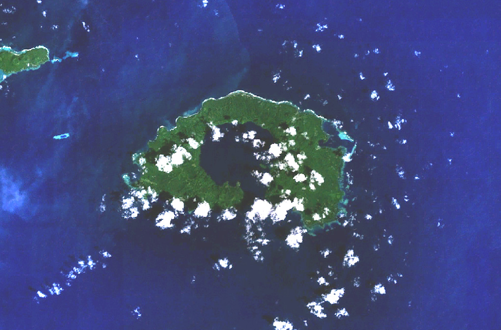 The most prominent feature of Garove Island, located N of New Britain, is a 5-km-wide caldera that is flooded by the sea through a narrow breach on the S side of the island, forming Johann Albrecht harbor. Satellite cones formed along the NE and SW coasts of the 12-km-wide island. No historical eruptions are known from Garove (also known as Vitu, or Witu), but the preservation of fresh lava flow structures on the NW coast suggests an age as young as a few hundred years. The E tip of Mundua Island is visible at the upper left. NASA Landsat 7 image (worldwind.arc.nasa.gov)