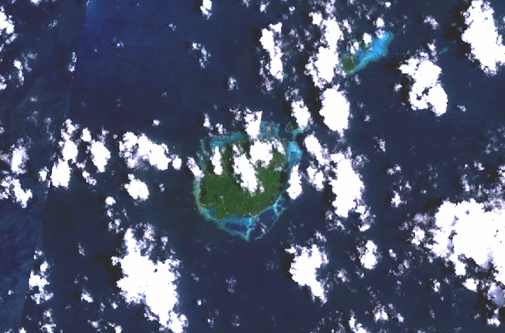 The circular, 5.5-km-wide island of Baluan (center) in the Admiralty Islands lies SE of Manus Island and across the St. Andrew Strait from Lou and Tuluman islands (out of view to the N). This Pleistocene volcano has a large summit crater and several flank vents. In contrast to its neighboring islands to the N, Baluan has erupted basaltic rather than rhyolitic rocks. The Pam Islands to the NE are visible at the upper right in this NASA Landsat image (N is to the top). NASA Landsat 7 image (worldwind.arc.nasa.gov)