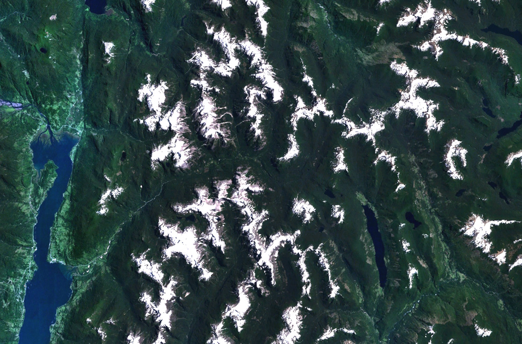 Cuernos del Diablo is a small 1862-m-high partially glacially eroded basaltic stratovolcano.  The volcano (not clearly seen in this NASA Landsat image with north to the top) is located about 30 km east of the elongated N-S trending Reloncavi fjord (far left), near the headwaters of the river extending diagonally to the center of the image from the lower left.  Numerous satellitic pyroclastic cones and associated basaltic lava flows were formed during the Holocene, some which may have historical in age, though eruptions were not recorded. NASA Landsat 7 image (worldwind.arc.nasa.gov)