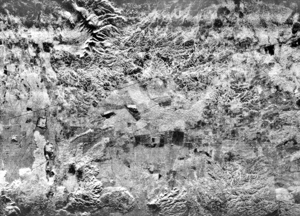 The flat-lying floor of the topographically indistinct 10-km-wide Malpaisillo pyroclastic shield volcano lies in the center of this radar image of the Nicaraguan depression.  The Malpaisillo road crosses the image diagonally from the SW to the NE, and the town of Malpaisillo is outlined in black below the road at the left-center.  Extensively dissected dacitic airfall and ignimbrite deposits are seen north of the 10-km-wide caldera, and lava flows from Las Pilas complex at the lower left lie SW of the caldera.    Radar image, 1971 (courtesy of Jaime Incer).