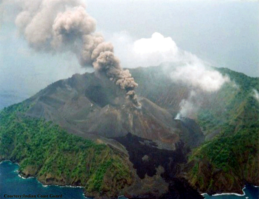Barren Island is shown erupting on 28 May 2005 from the WNW. The black lava flow in the foreground is from the 1994-95 eruption. A lava flow is being extruded from a flank vent below the white plume. Eruptions that began on 26 May occurred from the summit of the scoria cone as well as flank vents. Lava flows later reached the W coast along the same path as flows from the 1991 and 1994-95 eruptions. Photo courtesy of Indian Coast Guard, 2005.